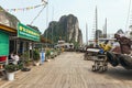 Boat stop with limestone cave with limestone island in background in summer at Quang Ninh, Vietnam