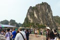 Boat stop with many tourists waiting for traveling inside limestone cave with limestone island in background in summer. Royalty Free Stock Photo