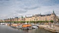 Boat and street cafe in old part of Stockholm, view from the riv