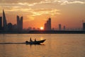 A boat during sunset with Bahrain highrise buildings Royalty Free Stock Photo