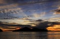 Boat at sunset behind island and clouds, Pasumpahan island, West Sumatra, Indonesia Royalty Free Stock Photo