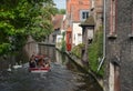 The boat and swans in Bruges canal