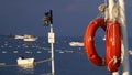 Red lifebuoys hang on the pier