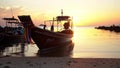 Boat sways in bay at coast of a tropical island. Evening, sunset in the ocean. Tropical landscape. Light waves rock the boat. Peop