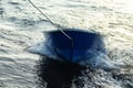 Boat is tethered behind fishing schooner