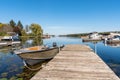 Boat tied up to an old wooden jetty in a harbour on a sunny autumn day Royalty Free Stock Photo