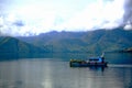 A Boat with Toba Caldera Background in Toba Lake, Samosir Island, North Sumatra, Indonesia.