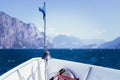 Boat tour: Boat bow, view over azure blue water and mountain range. Lago di Garda, Italy Royalty Free Stock Photo