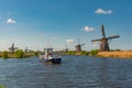 Boat tour in Kinderdijk village om the canal with historic Dutch windmills Netherlands Holland rural landscape popular destination Royalty Free Stock Photo