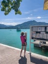 Boat tour at the Tegernsee. A mother with her cute little boy are waiting together for the coming ship to start a round