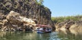 Boat with tourist passengers enjoying within marble rocks at panchwati,Bhedaghat, Madhya Pradesh,India.