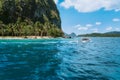 Boat with tourists on ipil beach of exotic island on hopping tour, Bacuit archipelago, El Nido, Palawan , Philippines Royalty Free Stock Photo