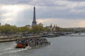 Boat with tourists on the Seine River with Eiffel Tower in the background. Royalty Free Stock Photo