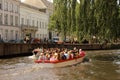 Boat of tourists travelling down the river in the city of Bruges, Belgium.