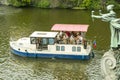 Boat with tourists on the Vltava river in Prague