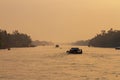 Boat traffic and birds on Mekong River in Vietnam at sunset Royalty Free Stock Photo