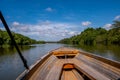 A boat traveling down a jungle river in Asia Royalty Free Stock Photo