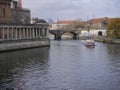 Boat travels under rail bridge on River Spree in central Berlin, Germany