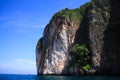 Boat trip along the coast line of tropical island Ko Phi Phi along impressive rock formations under blue sky Royalty Free Stock Photo