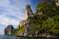 Boat trip along the coast line of tropical island Ko Phi Phi along impressive rock formations under blue sky Royalty Free Stock Photo