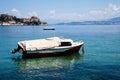 Boat trip along a river in Corfu Greece. Ship on clean blue water. Island houses on the shore view. Greek beautiful landscape. Whi