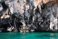 Boat trip around impressive steep rough cliffs of tropical island Ko Phi Phi, Thailand