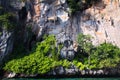 Boat trip around impressive steep rough cliffs of tropical island Ko Phi Phi, Thailand