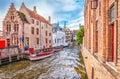 Boat trip on canal of Bruges. Popular for tourists who visit Belgium. Royalty Free Stock Photo