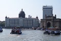 Taj Mahal hotel, Gateway of India and tourist boats in water of Arabian Sea in Mumbai Royalty Free Stock Photo