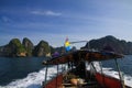 Boat Trip to islands along steep cliffs in blue Andaman Sea near Ao Nang, Krabi