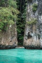 Boat trip to tropical islands. View on beautiful small deserted sandy beach isolated between rocks with turquoise sea