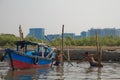 Boat and two workers of the Sunda Kelapa harbour Jakarta, Indone