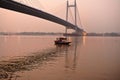 boat under the towering " bidyasagar bridge" at Kolkata, india