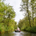 Boat with unrecognisable people in the Weerribben Royalty Free Stock Photo