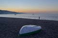 Boat upside down on the beach of Castell de Ferro during a sunrise. Fisherman silhouette, boats in the sea