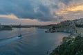 Boat in Valletta harbor at dusk, Malta, Europe