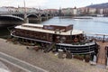 Boat on Veltava river and bridge Royalty Free Stock Photo