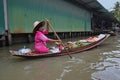 Boat vendor selling tropical fruits nearby floating market around Bangkok area Royalty Free Stock Photo