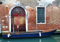 Blue Boat on small side canal and old house venice Italy Royalty Free Stock Photo