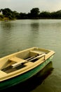 A boat waiting for riders with paddles in the lake at sittanavasal cave temple complex.