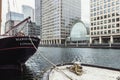 Boat in water with modern buildings in Canary Wharf Royalty Free Stock Photo