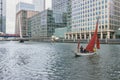 Boat in water with modern buildings in Canary Wharf Royalty Free Stock Photo