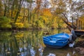 Boat with water reflection in the colorful autumn at a river pier Royalty Free Stock Photo