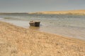 The boat in the water. Rowing boats in the reeds. Wooden boat on the lake on a summer day. Aral sea, Kazakhstan Royalty Free Stock Photo