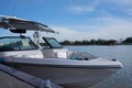 boat for water sports stranded at the pier during the midday with blue sky and a lake in the background