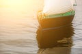 Boat with white sails floating in the water close up. Royalty Free Stock Photo