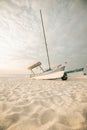 Boat on white sand on the sea coast at sunset.Sea transport. Sandy white dunes.Beach summer background.Windy weather at Royalty Free Stock Photo