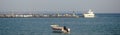 Boat and a white ship in a port