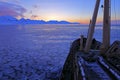 Boat in winter Arctic. White snowy mountain, blue glacier Svalbard, Norway. Ice in ocean. Iceberg twilight in North pole. Pink clo Royalty Free Stock Photo