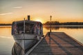 Boat at the wooden pier durin sunset Royalty Free Stock Photo